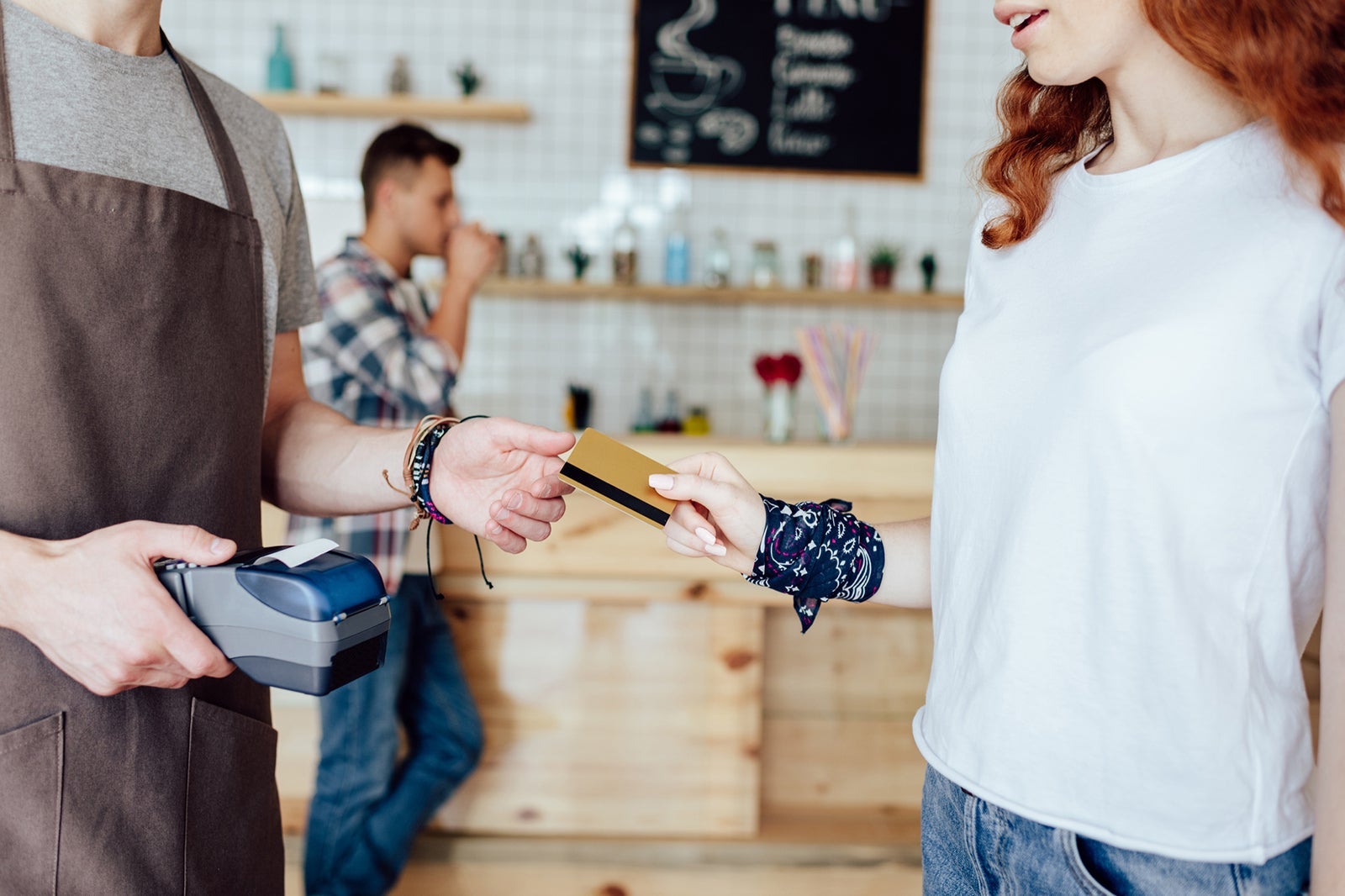 Person handing credit card to make payment