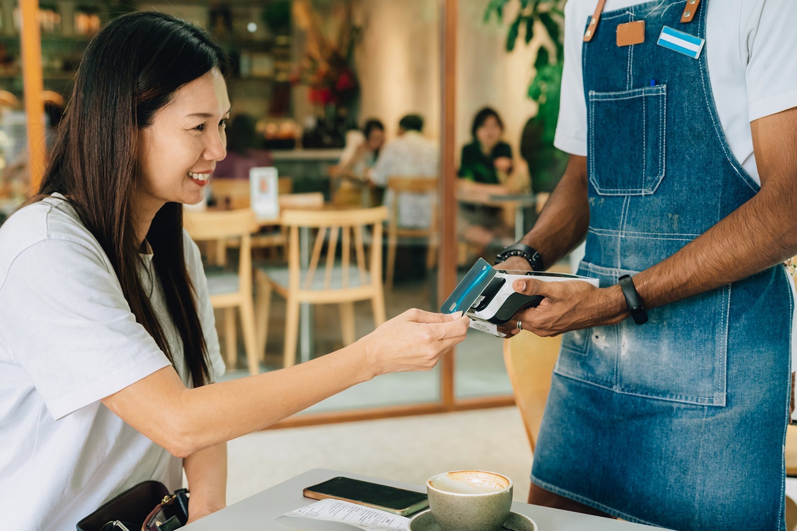 Woman paying for coffee