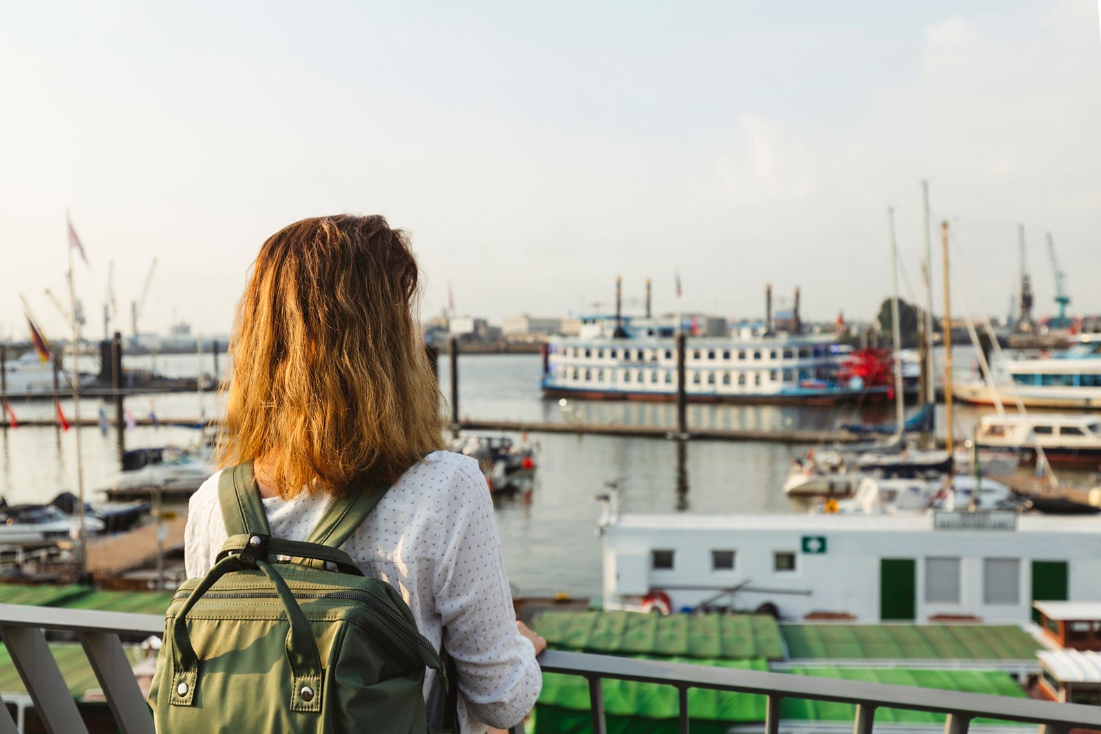 Woman standing by railing at Port of Hamburg, Germany