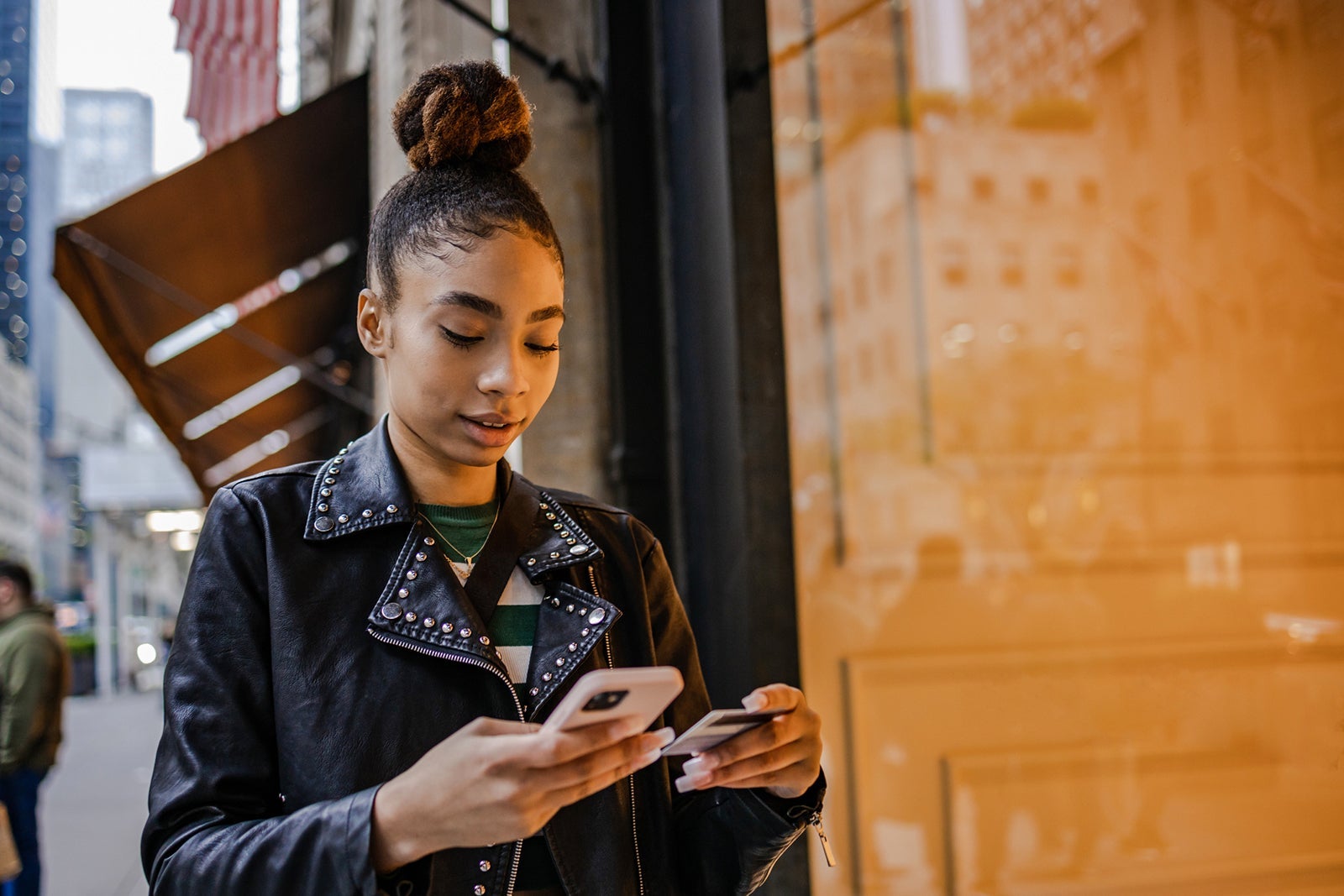 Woman using her cell phone for a purchase