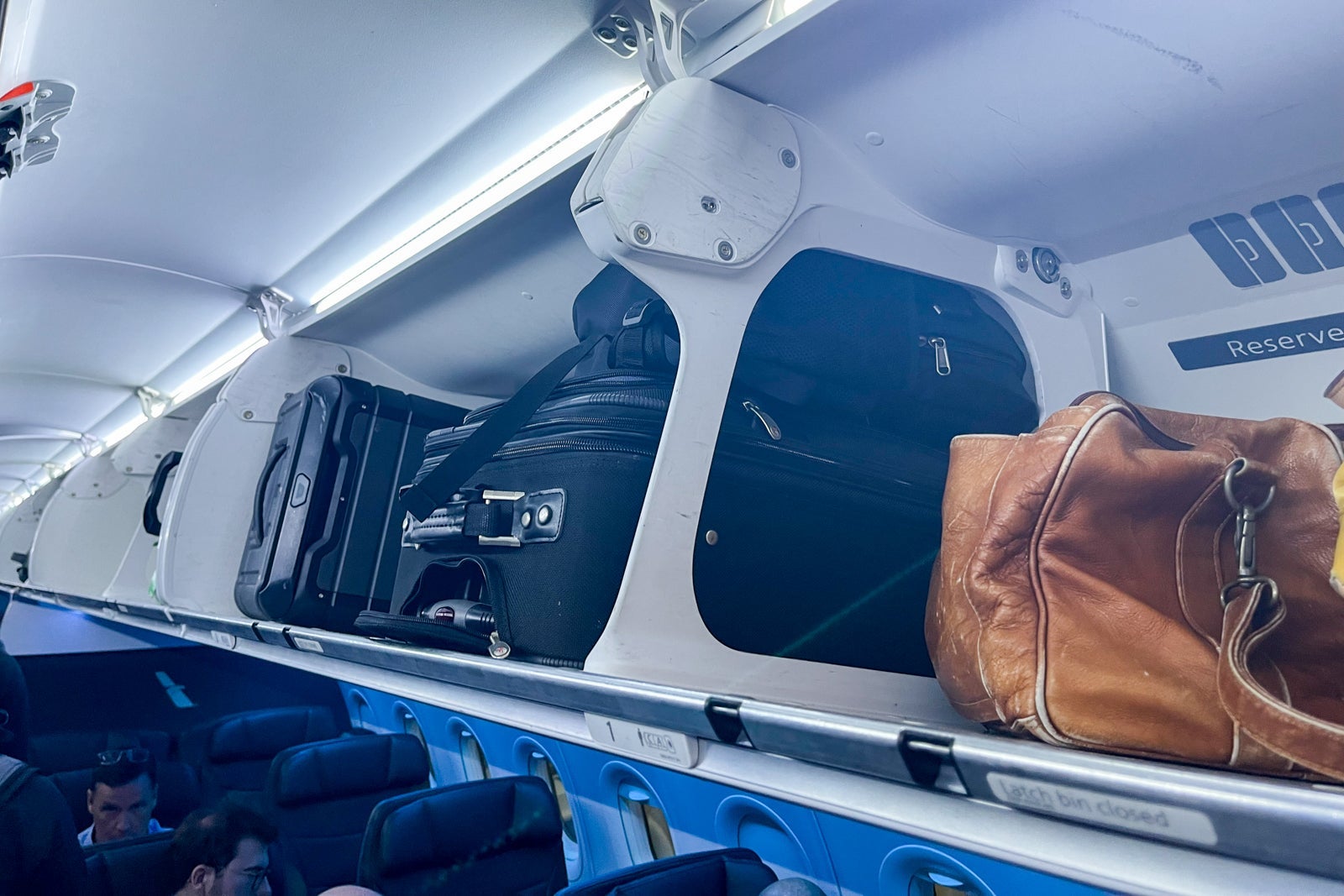 suitcases in overhead bin