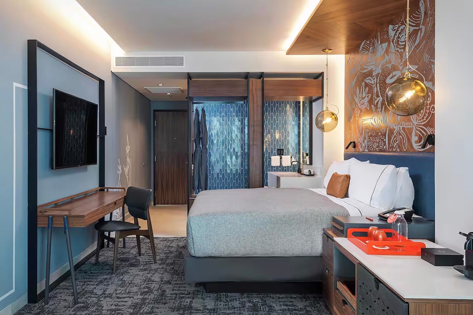 modern hotel room with mural above bed