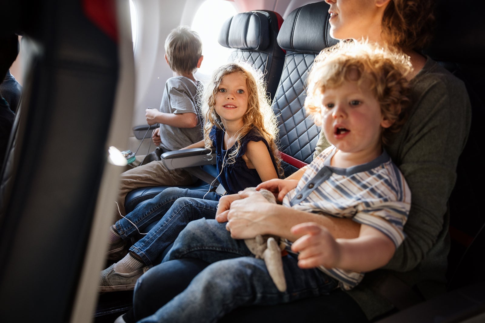 Family Traveling on Airplane Together