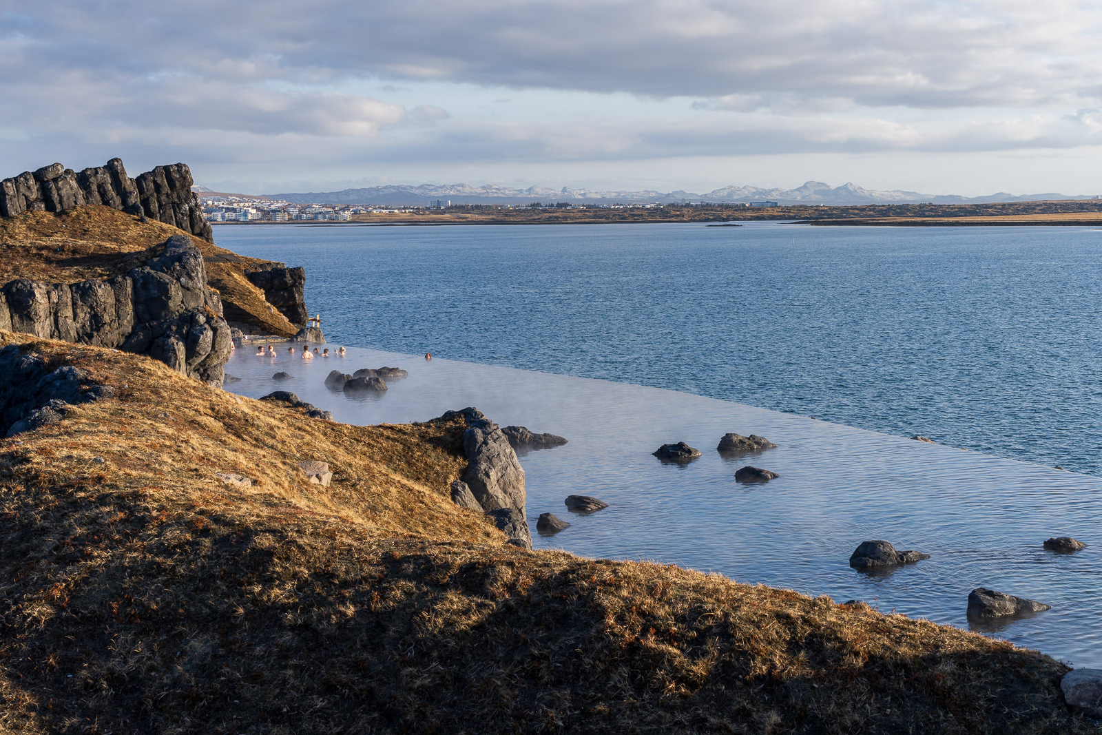 People relaxing in the Sky Lagoon in Iceland