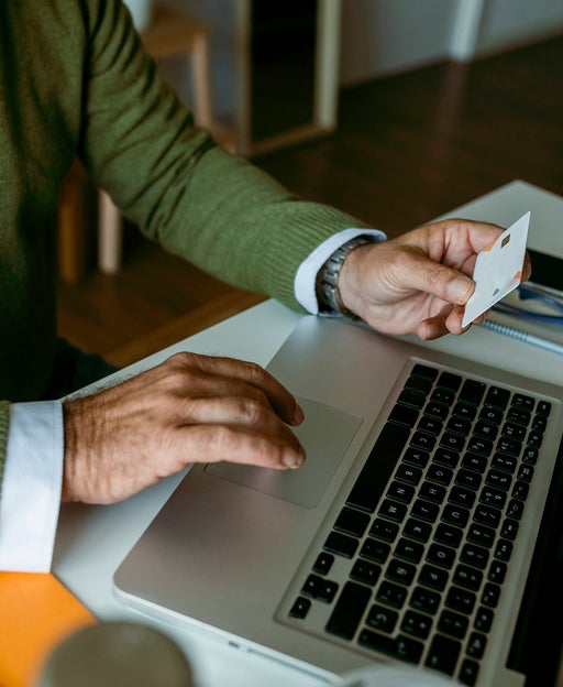 A man entering credit card info into a laptop