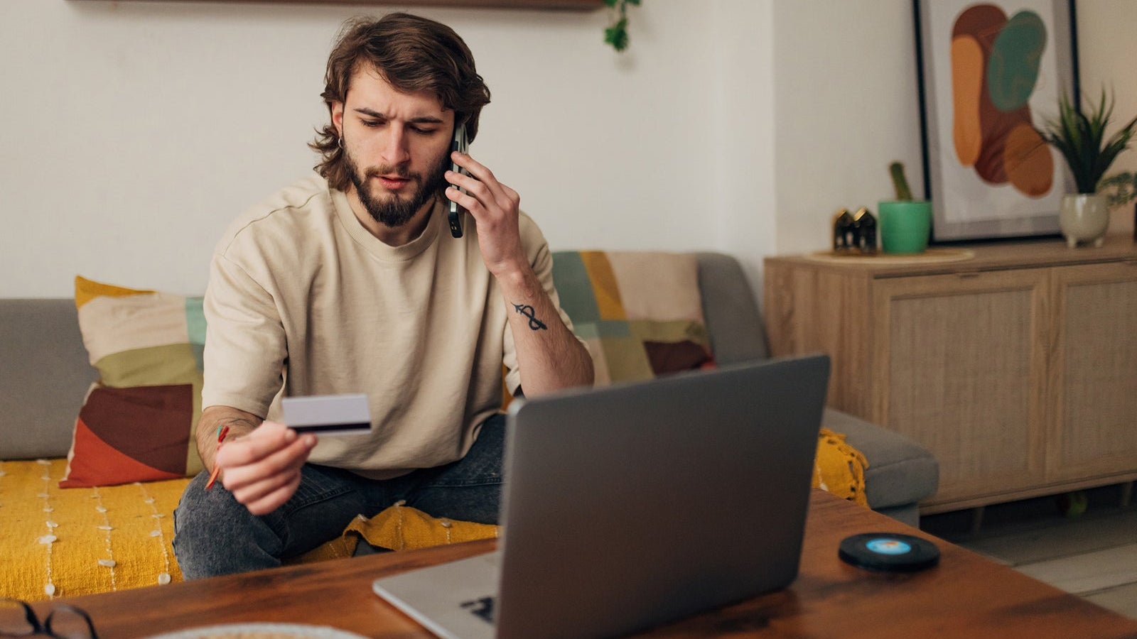 Male bank client notices a problem and is worried about a credit card problem, the threat of financial fraud