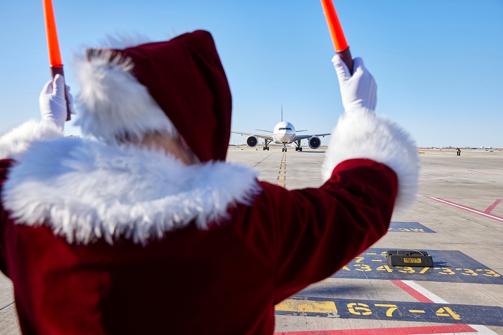 Santa Claus directing plane traffic