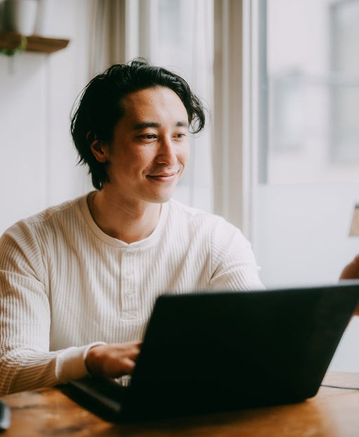 Man shopping online with credit card at home