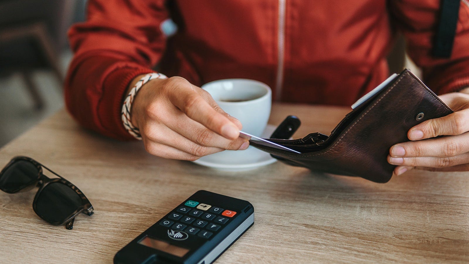 Man paying contactless in cafe