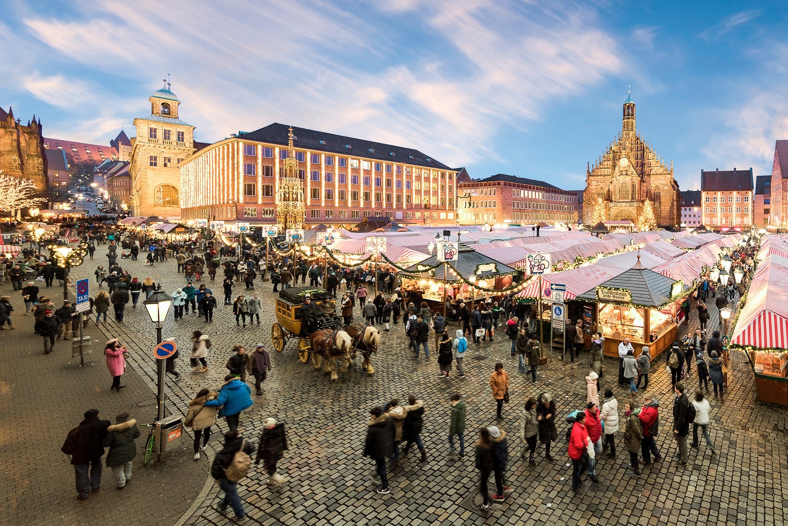 Christmas Market "Christkindlesmarkt" with Church of Our Lady in the background, Nuremberg, Bavaria, Germany.