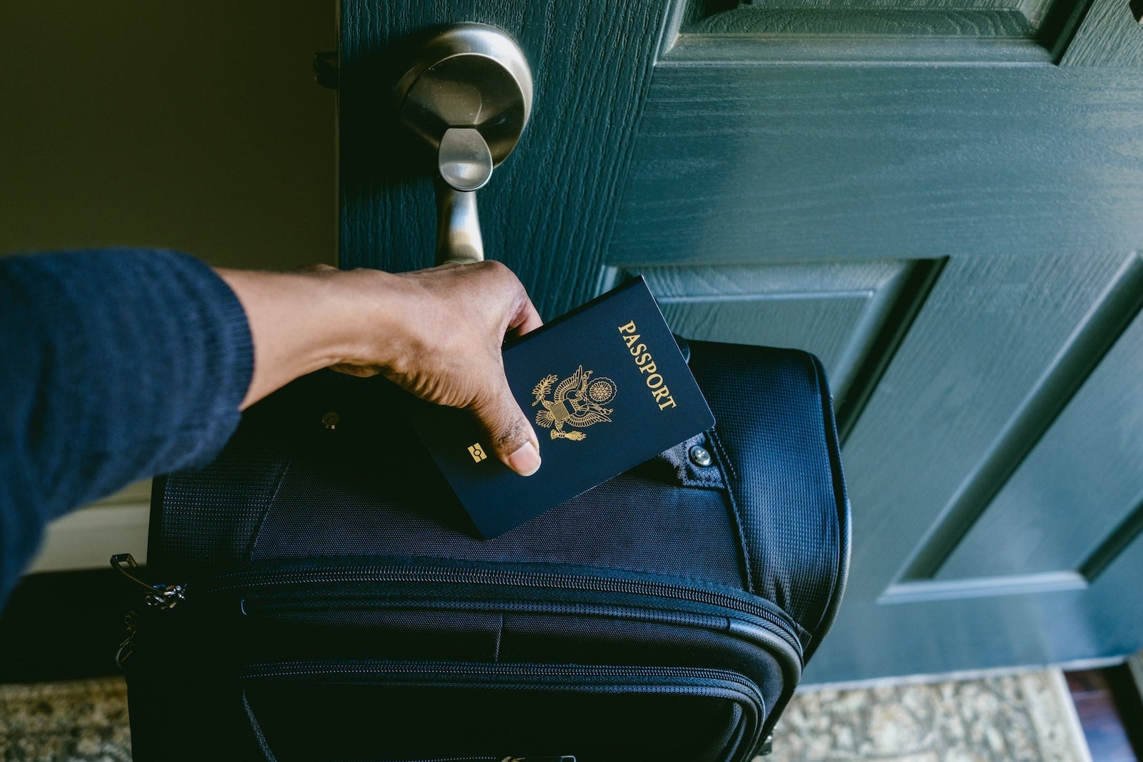 Woman Prepares to Leave House With Packed Suitcase and Passport