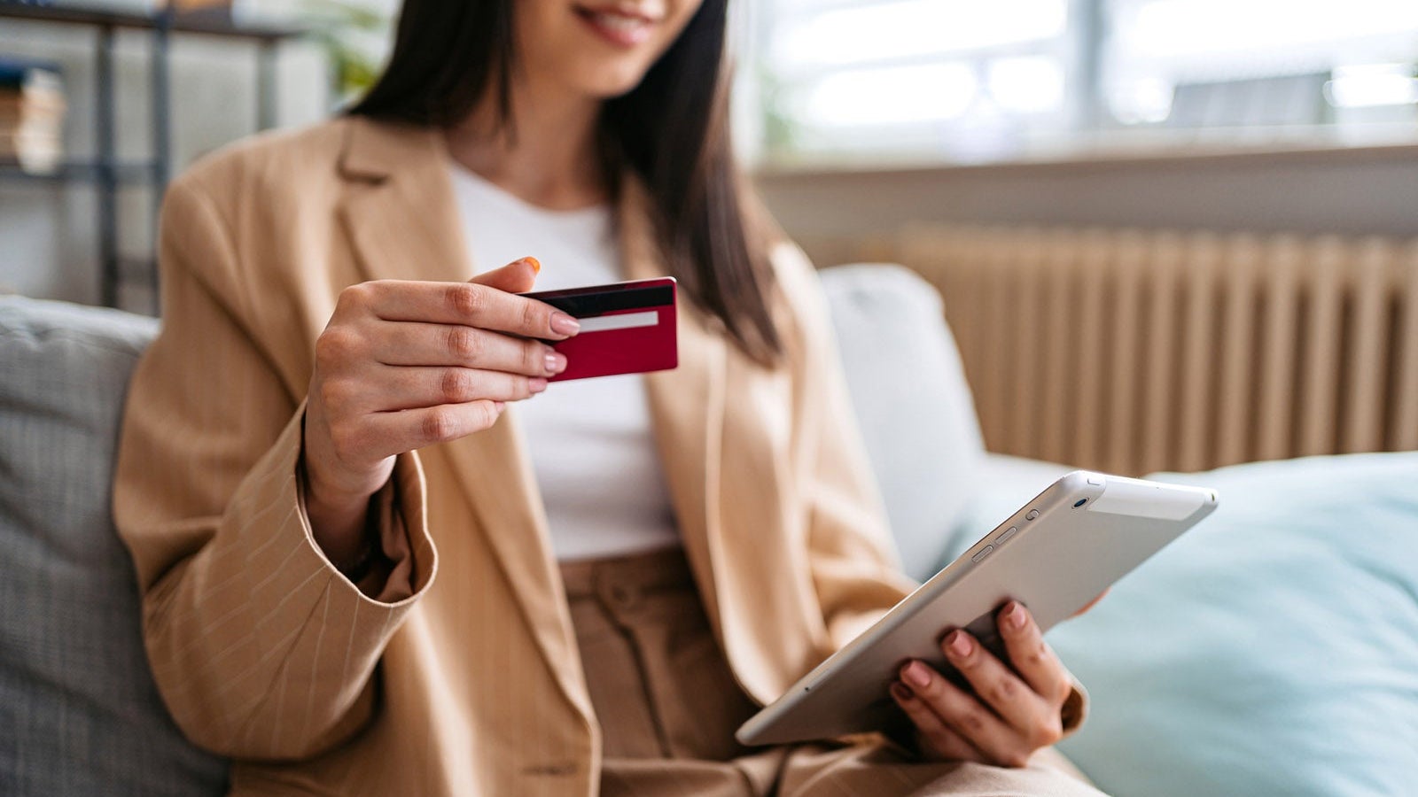 Woman Shopping Online Using Digital Tablet At Home