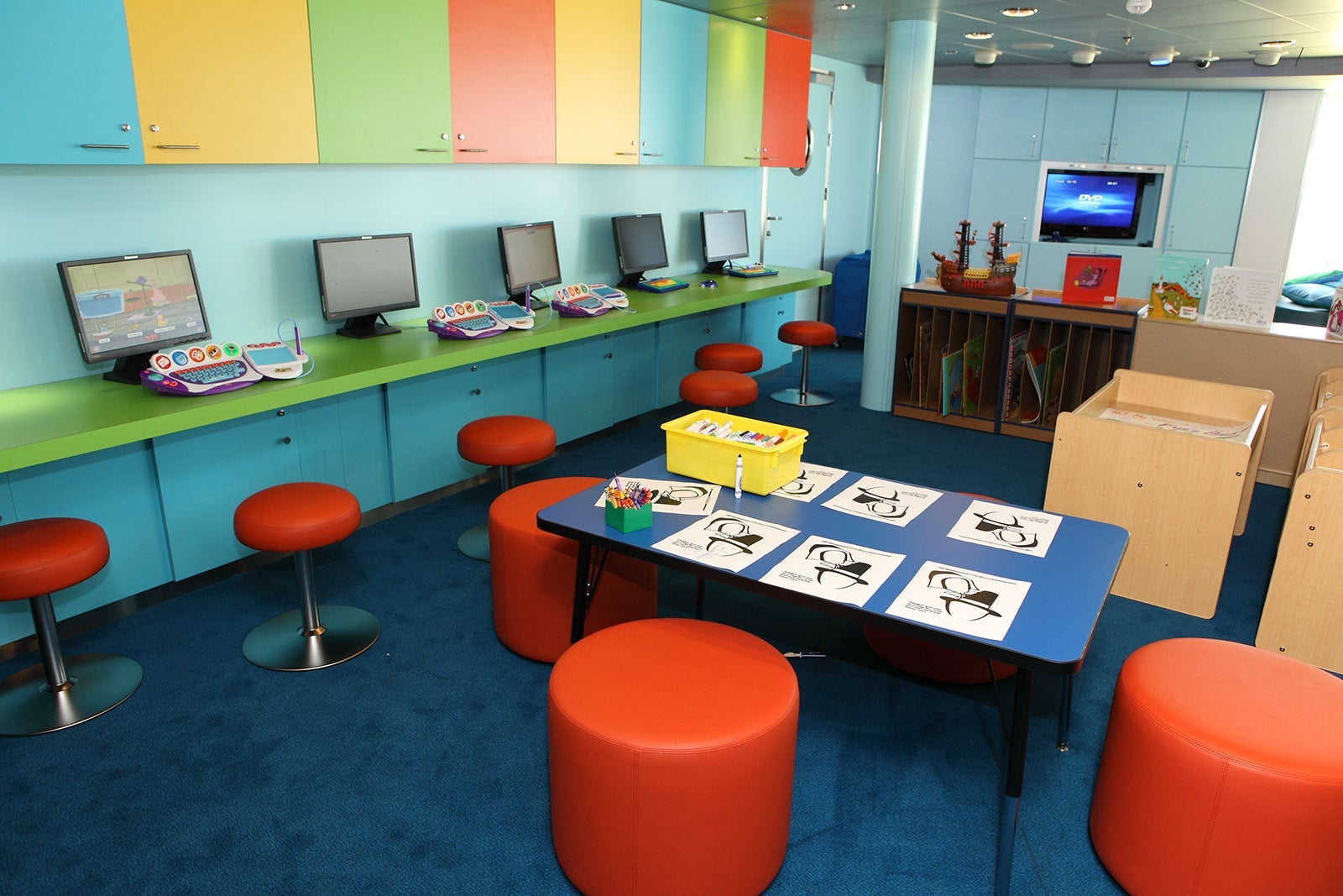 Kids playroom on a cruise ship with tables for art and video games