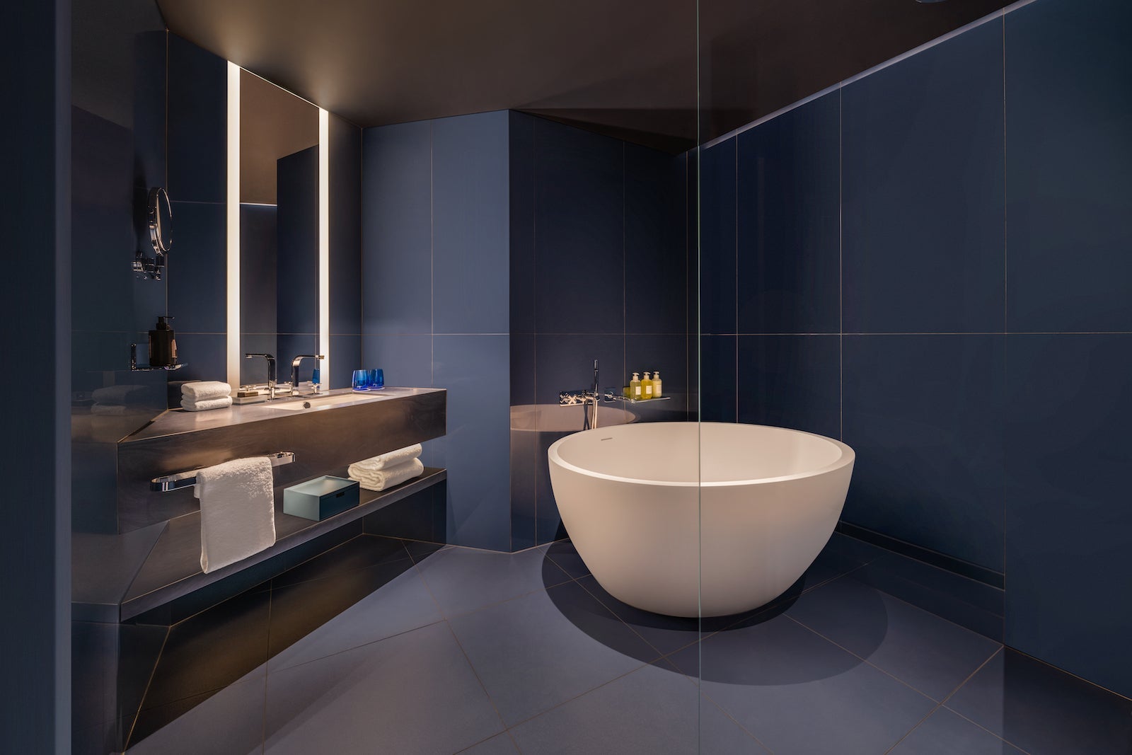 A blue bathroom with a soaking tub at the W Sydney