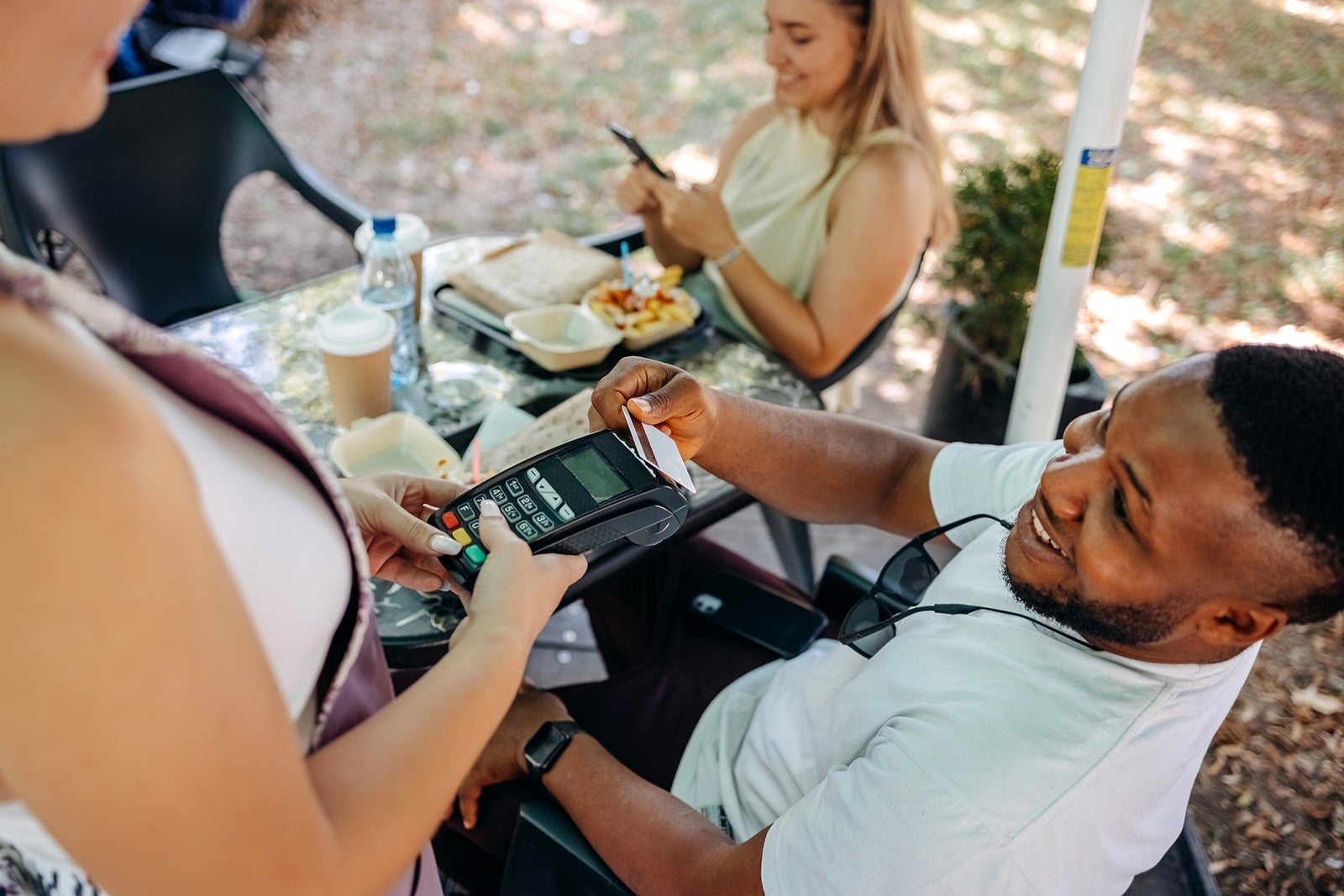 Person using tap to pay at a restaurant
