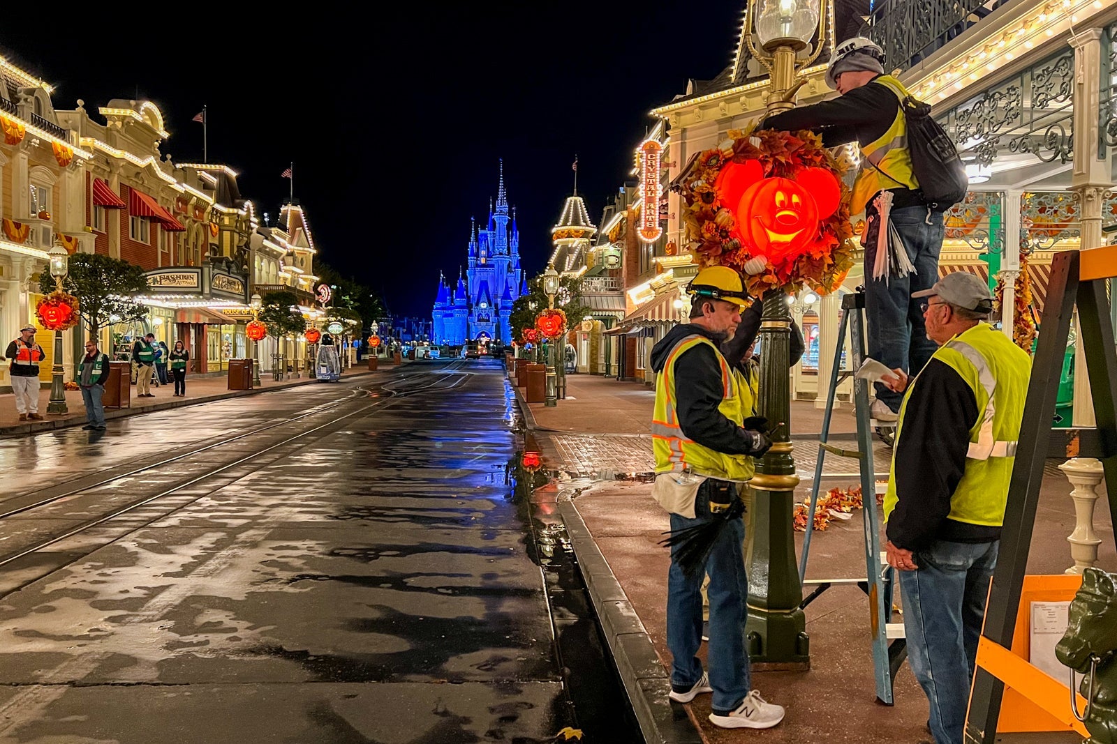 Crew puts up Christmas decorations at the Magic Kingdom