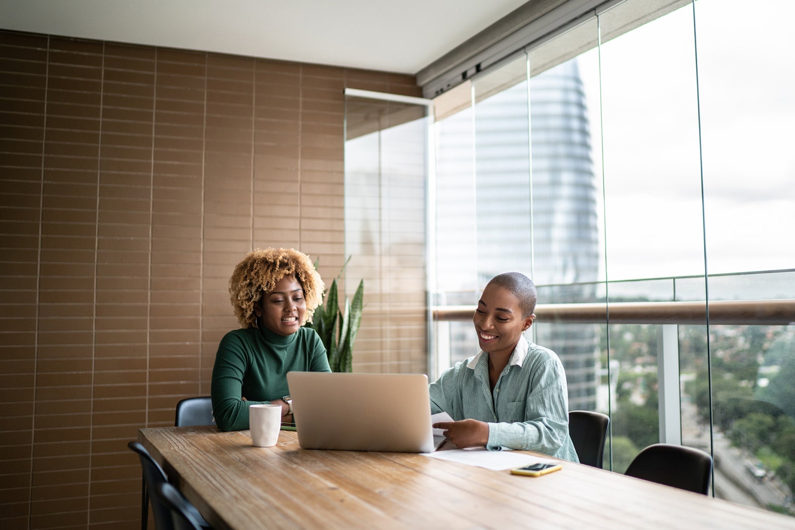 two people working on laptop