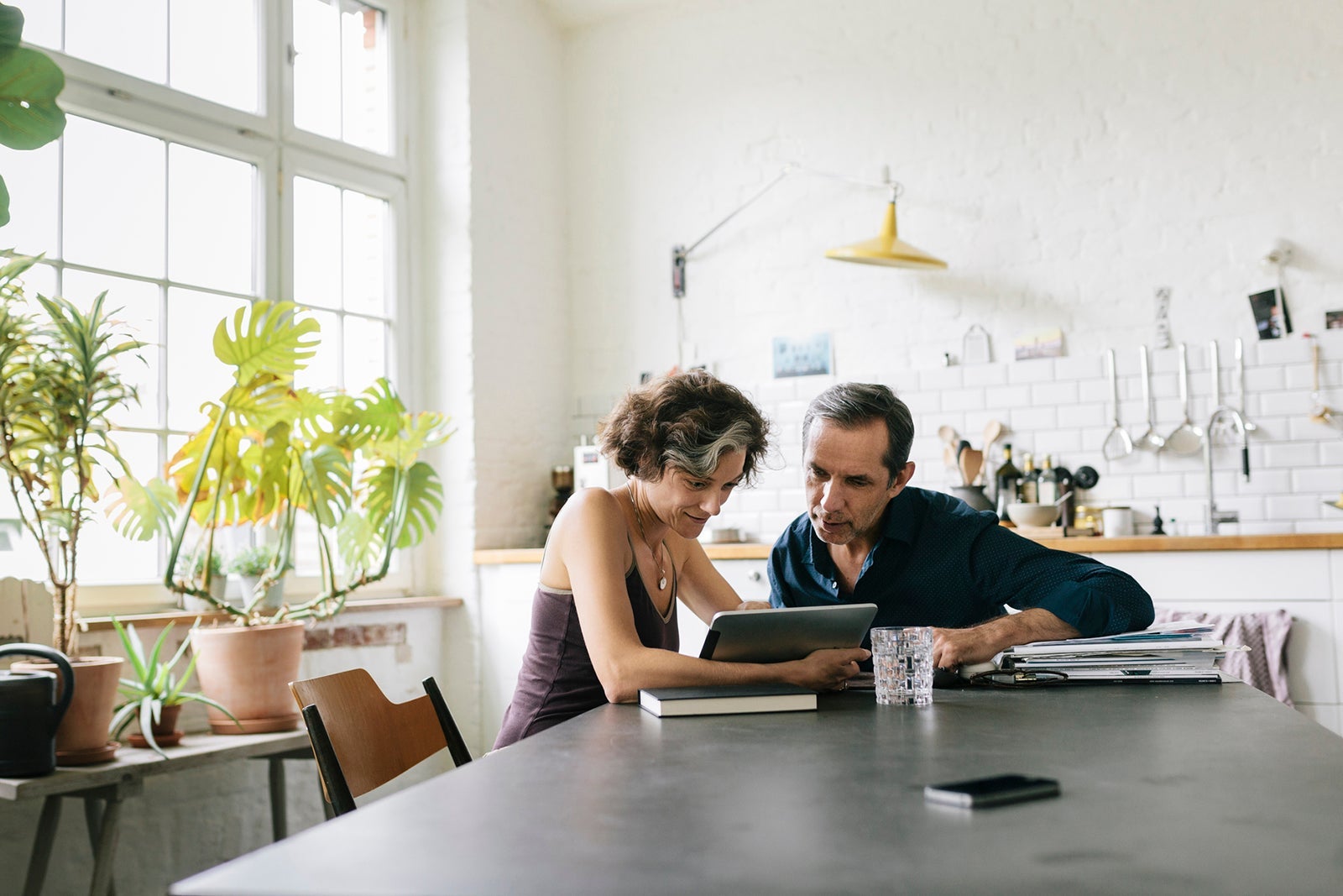 couple looks at computer at home