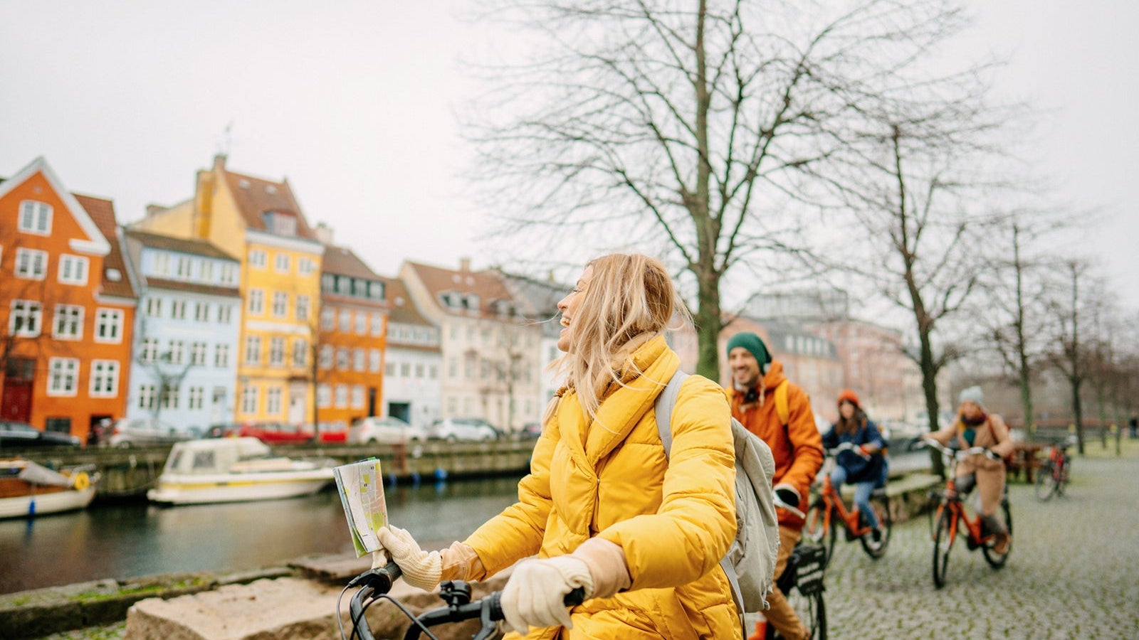 Travel guide and her group on the bicycles through the town