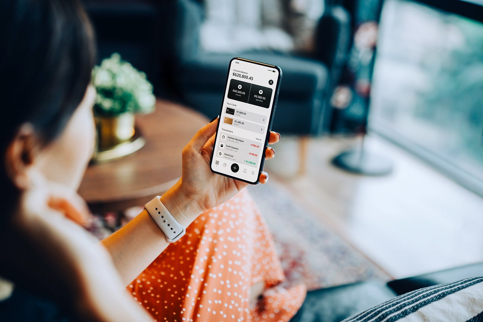 woman looking at banking transactions on her phone