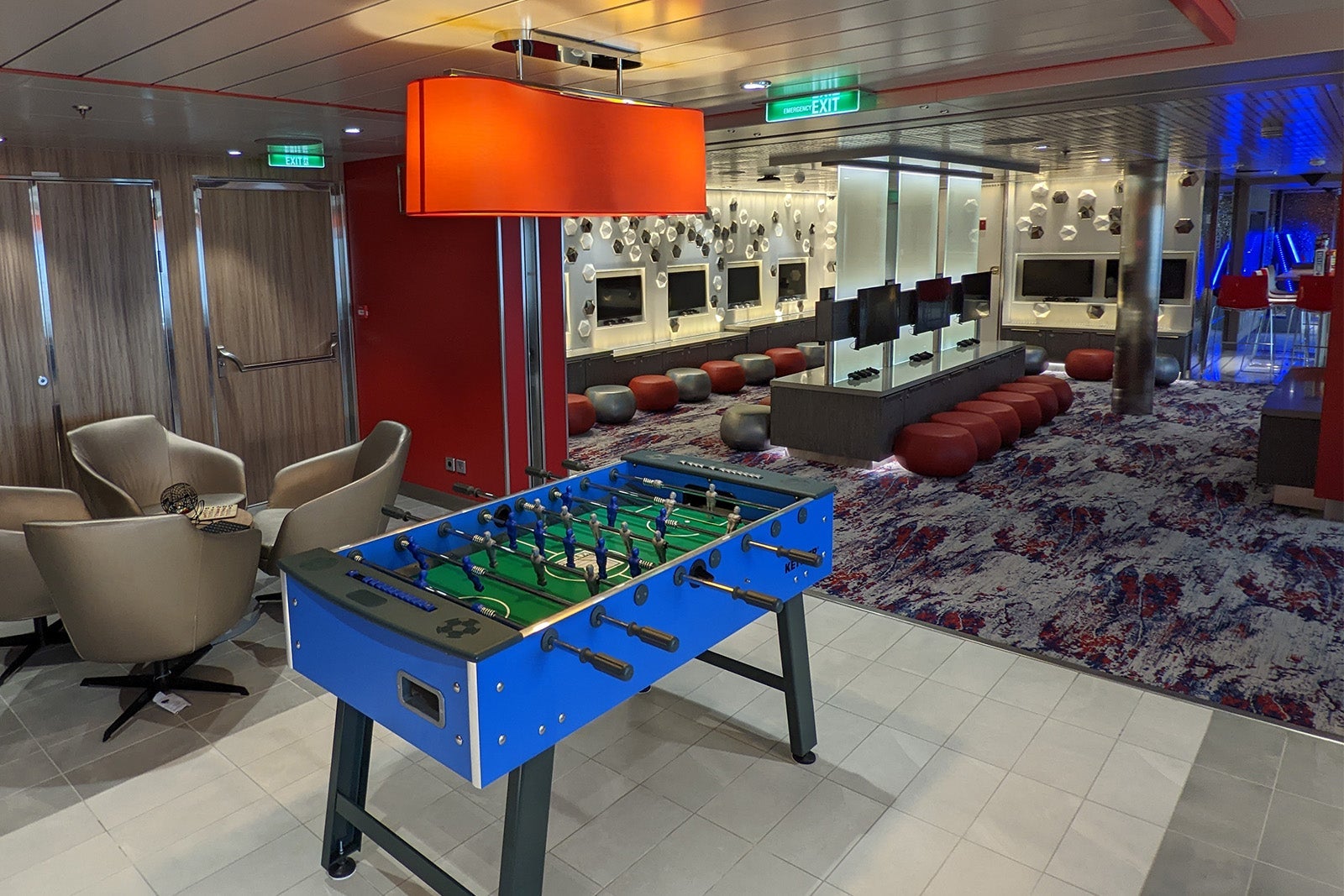 Foosball table and gaming stations in cruise ship teen club