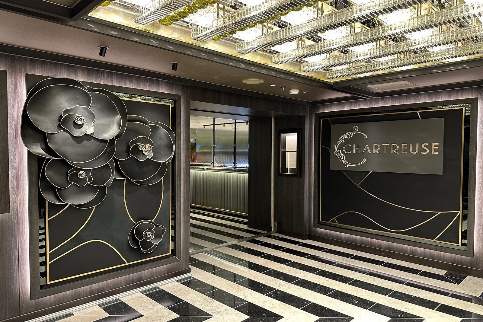 A wall adorned with large black leather flowers and a black-and-white striped floor