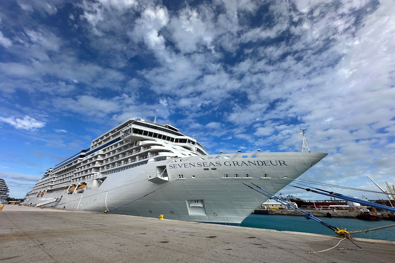 A white cruise ship docked at a pier