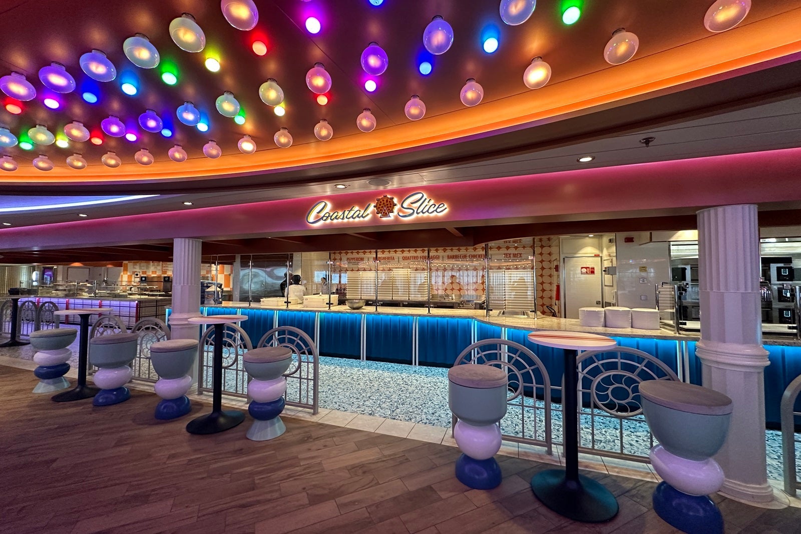 A boardwalk-style walk-up counter-service window serving pizza