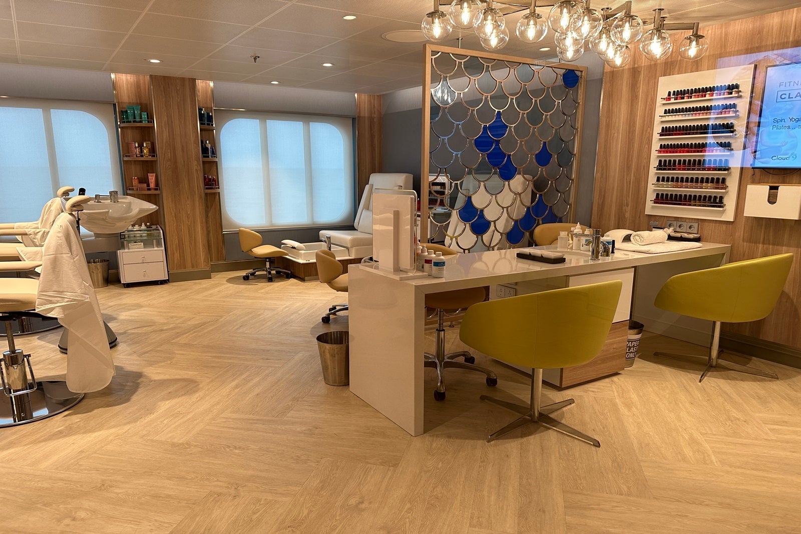 A nail salon with treatment tables and pedicure chairs