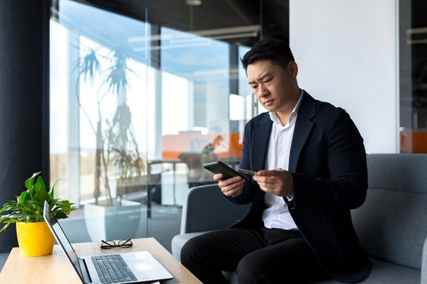 Unhappy Confused, angry asian man shopping online. customer cannot pay by bank credit card. having problems paying feel frustrated stressed with failed transaction internet on computer laptop screen