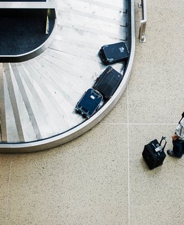 Couple waiting for luggage at baggage claim