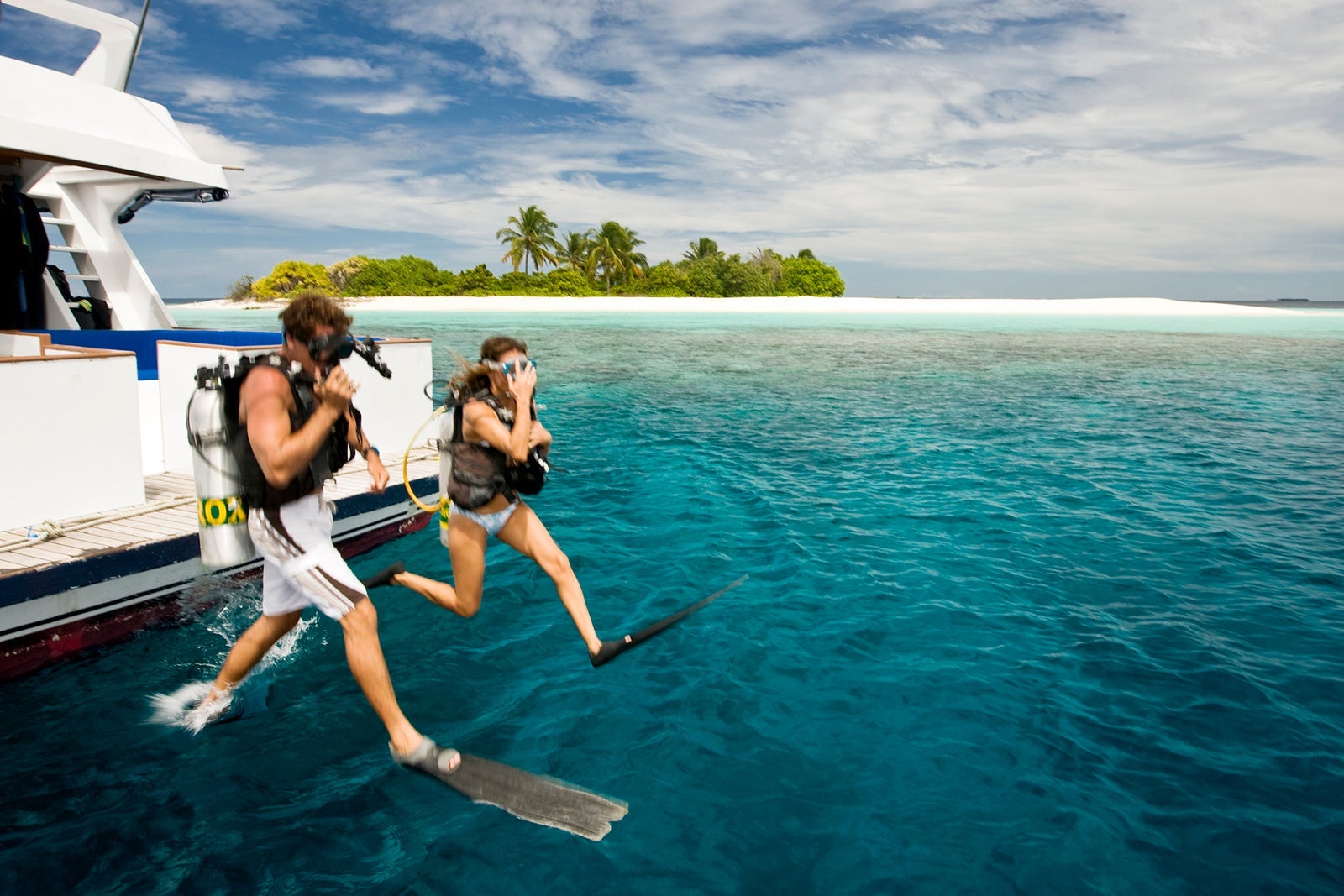 Divers Jumping into Ocean, Maldives