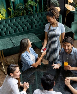 Woman paying by card at a restaurant