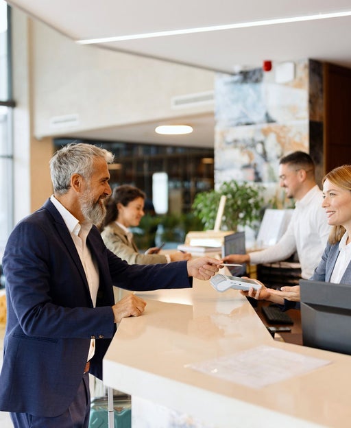 A man checking into a hotel