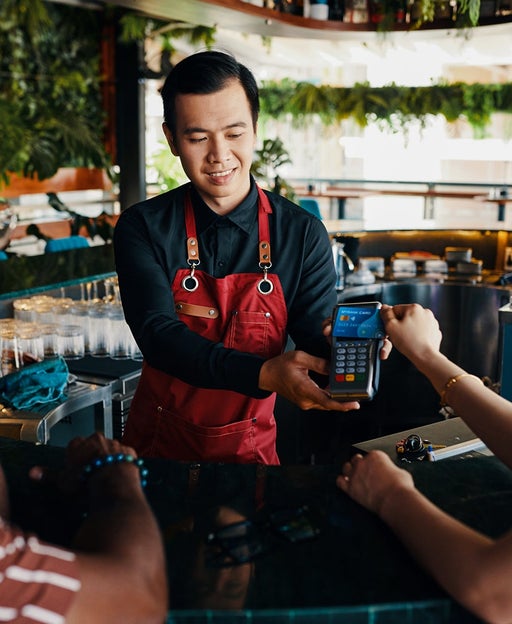 Woman Paying Bill in Bar