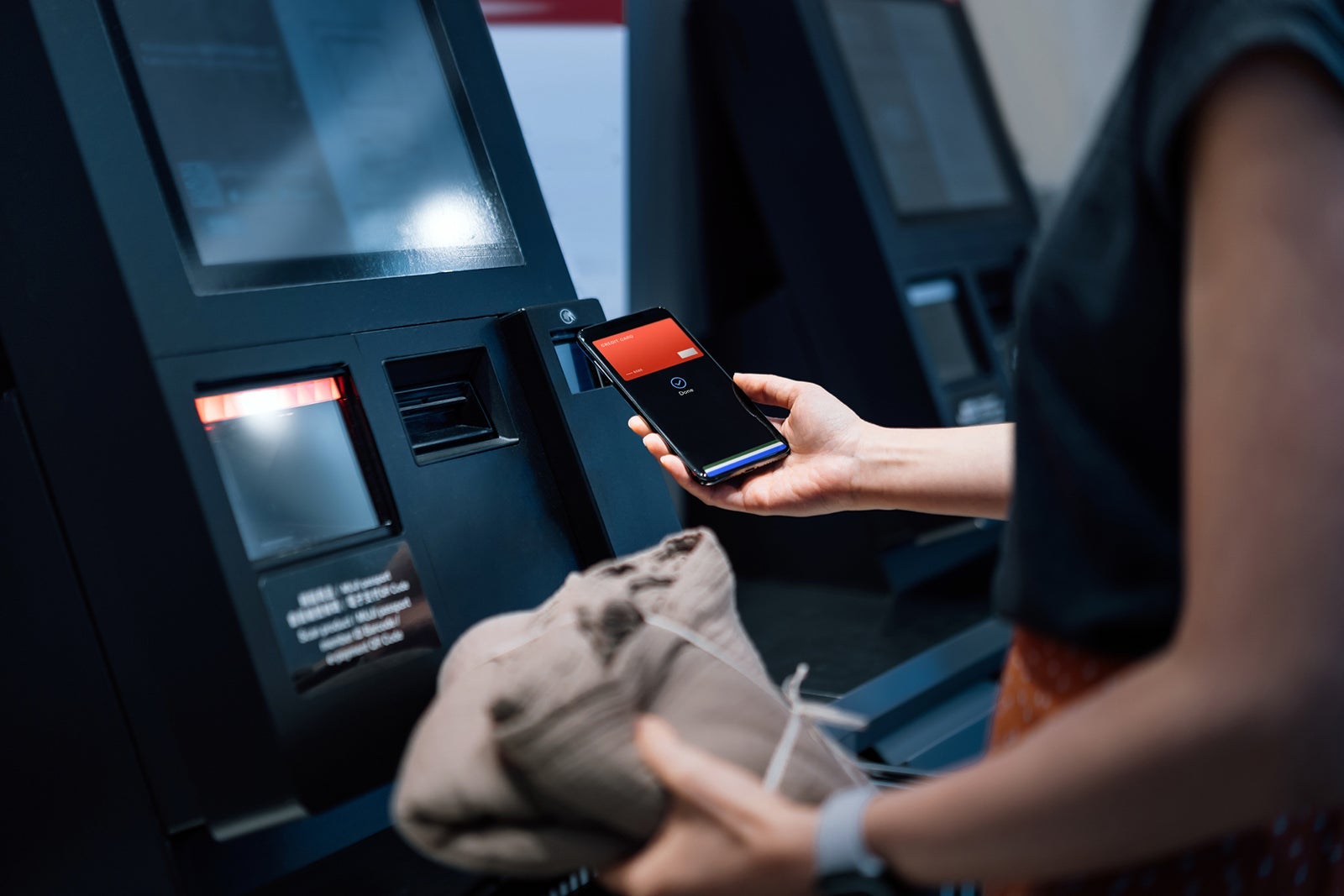 woman with card at atm