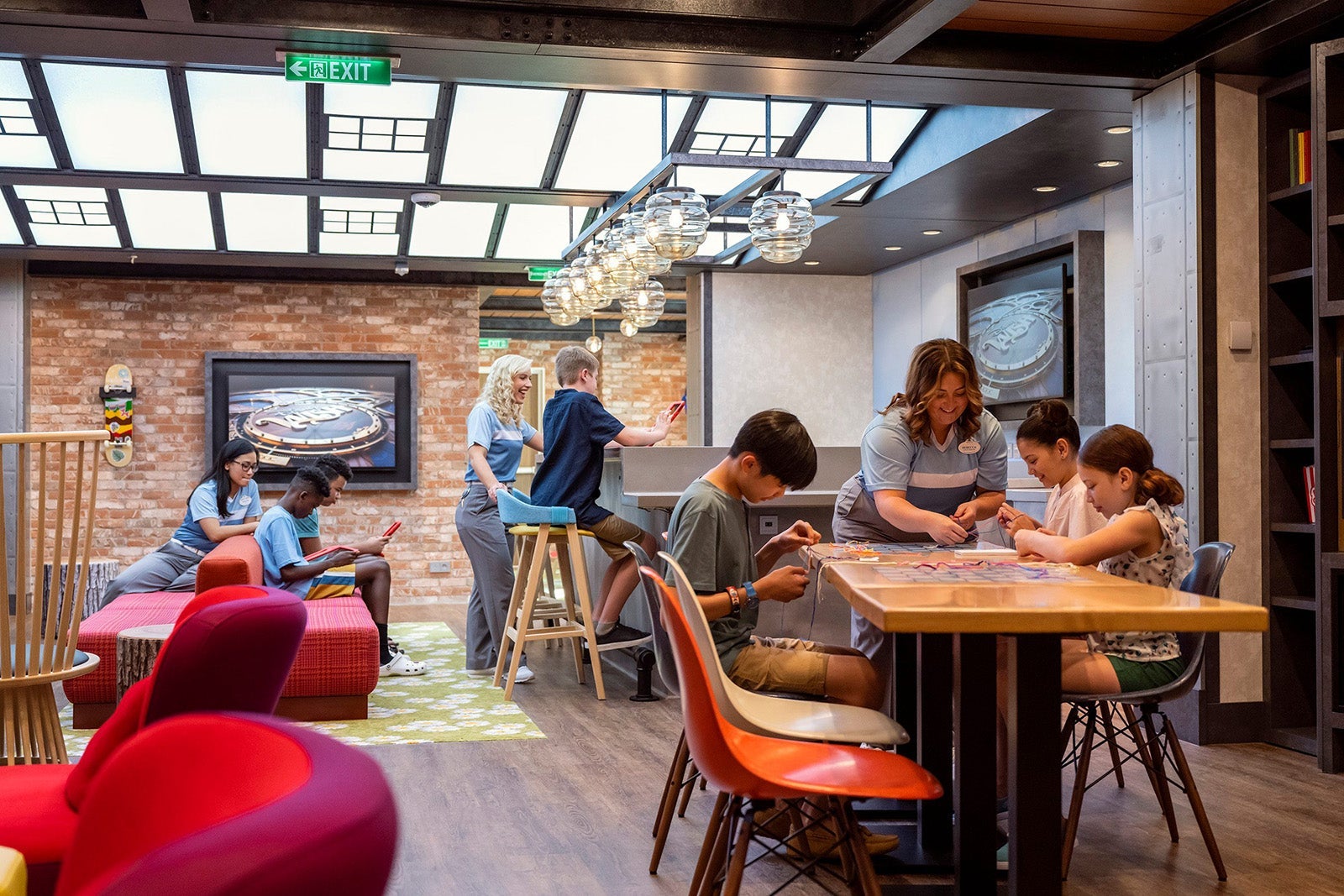 Youth staff and tweens play games in the Edge tween club on the Disney Wish cruise ship