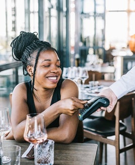 Woman tapping a card to pay