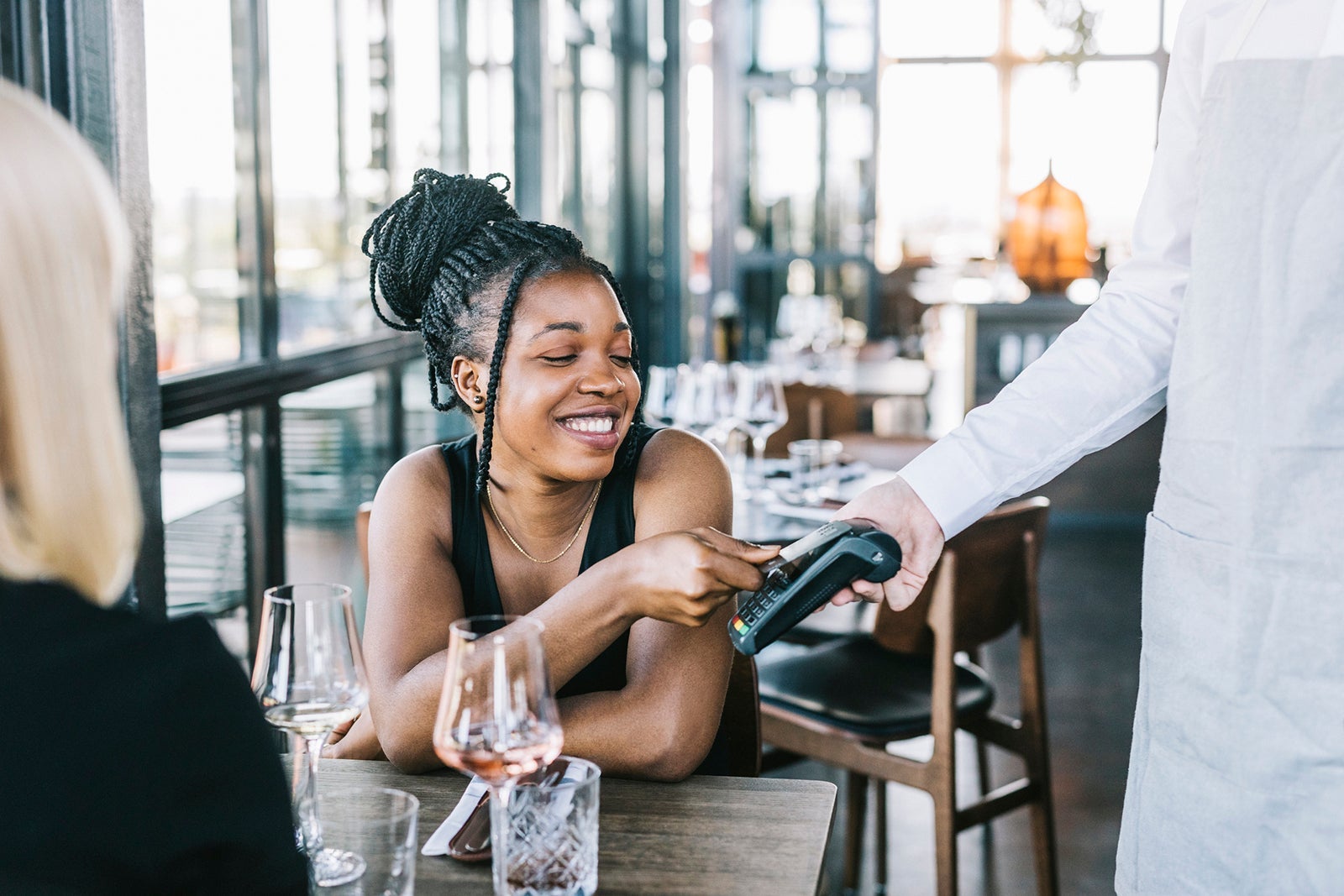 Woman tapping a card to pay