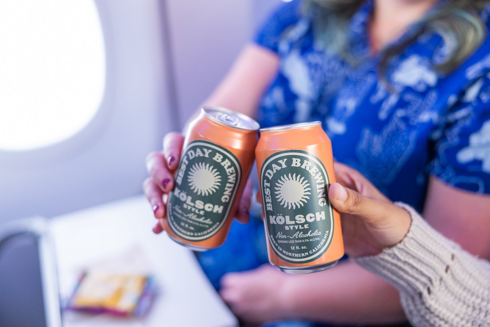people on flight toasting drinks
