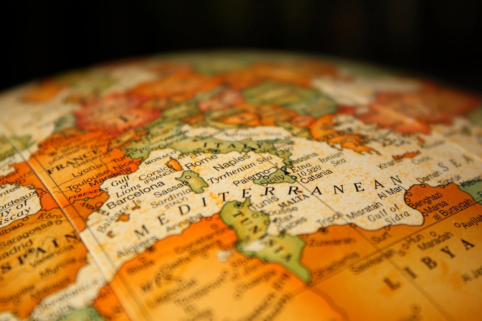 A close-up of the top of a globe with a black background