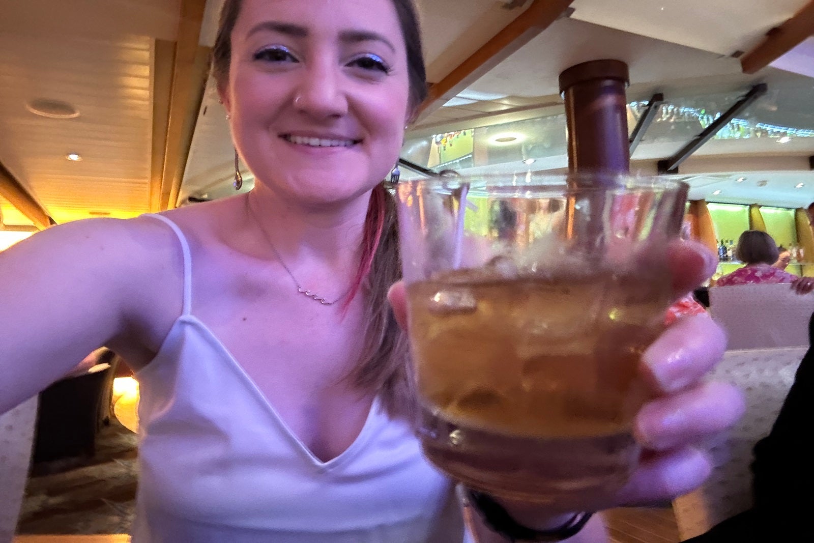 A woman holding a cocktail