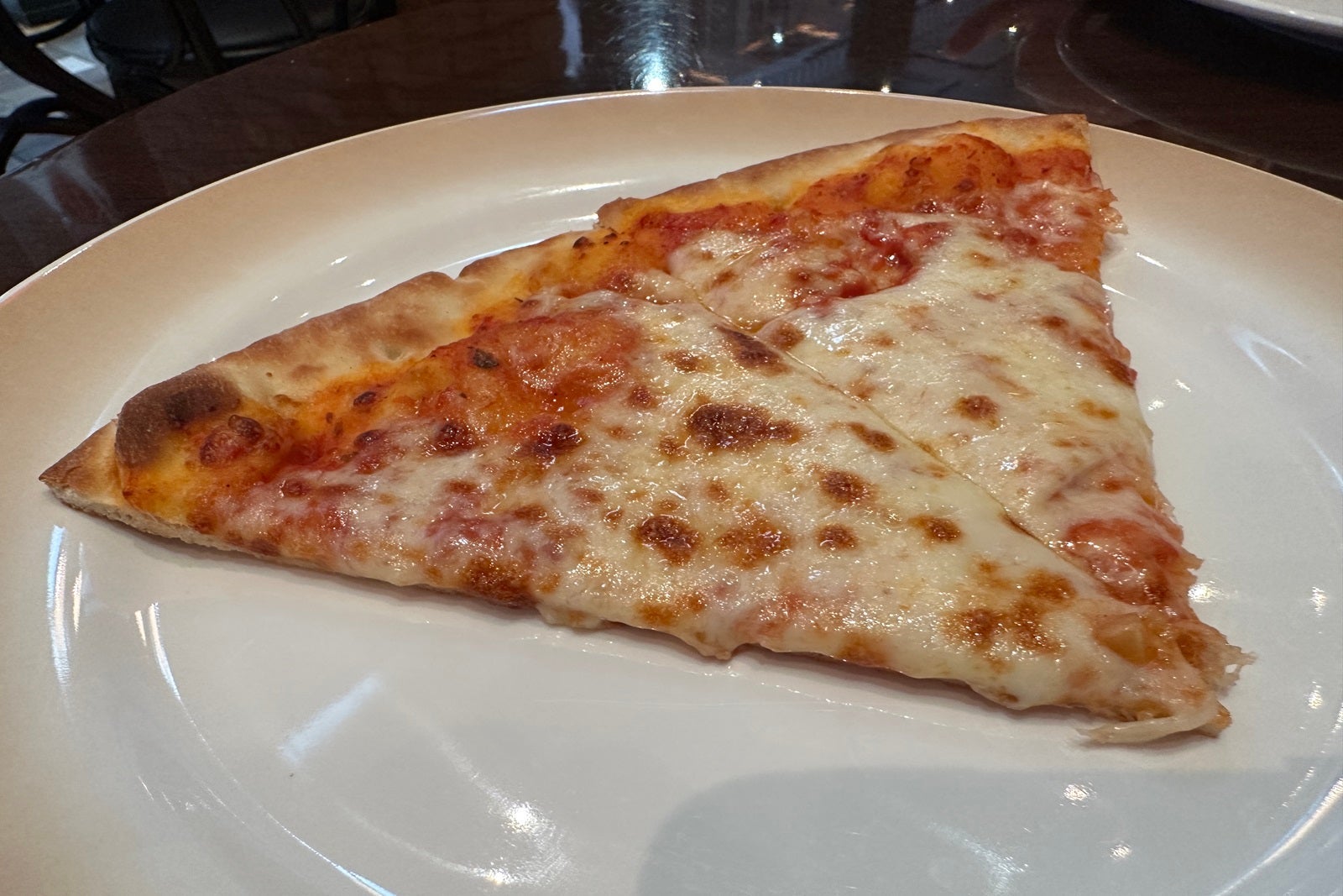 Two slices of pizza on a white plate