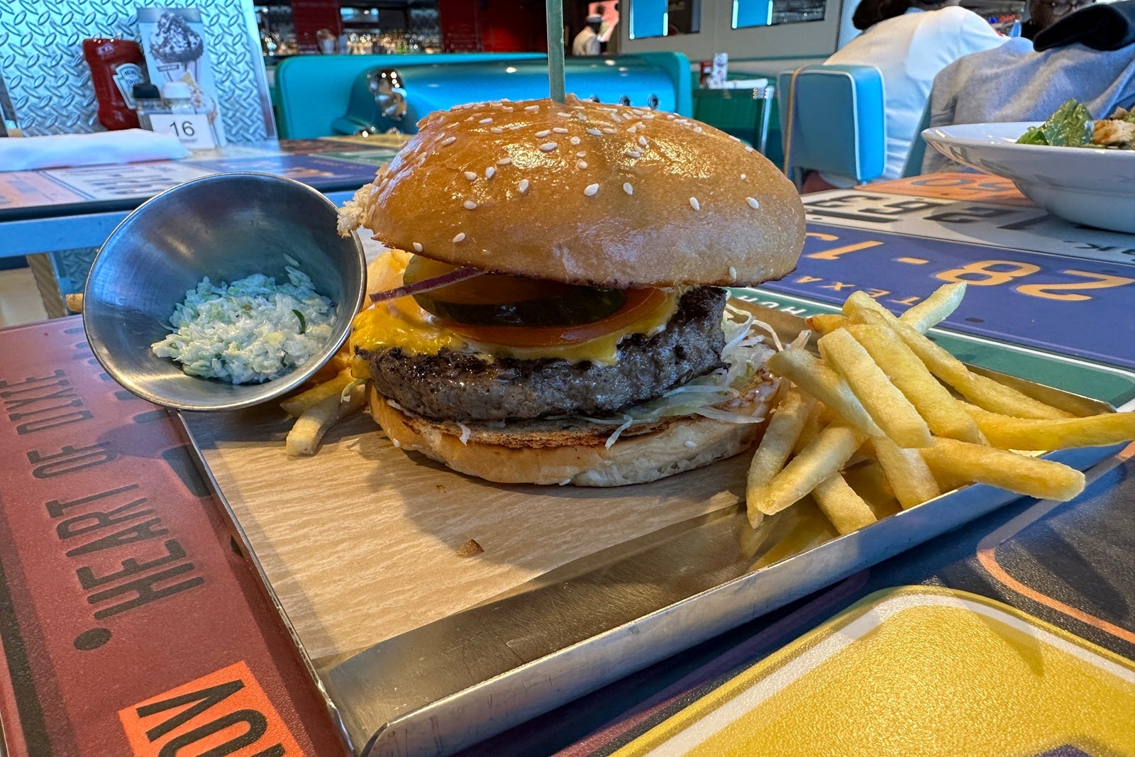 A cheeseburger and fries on a tray