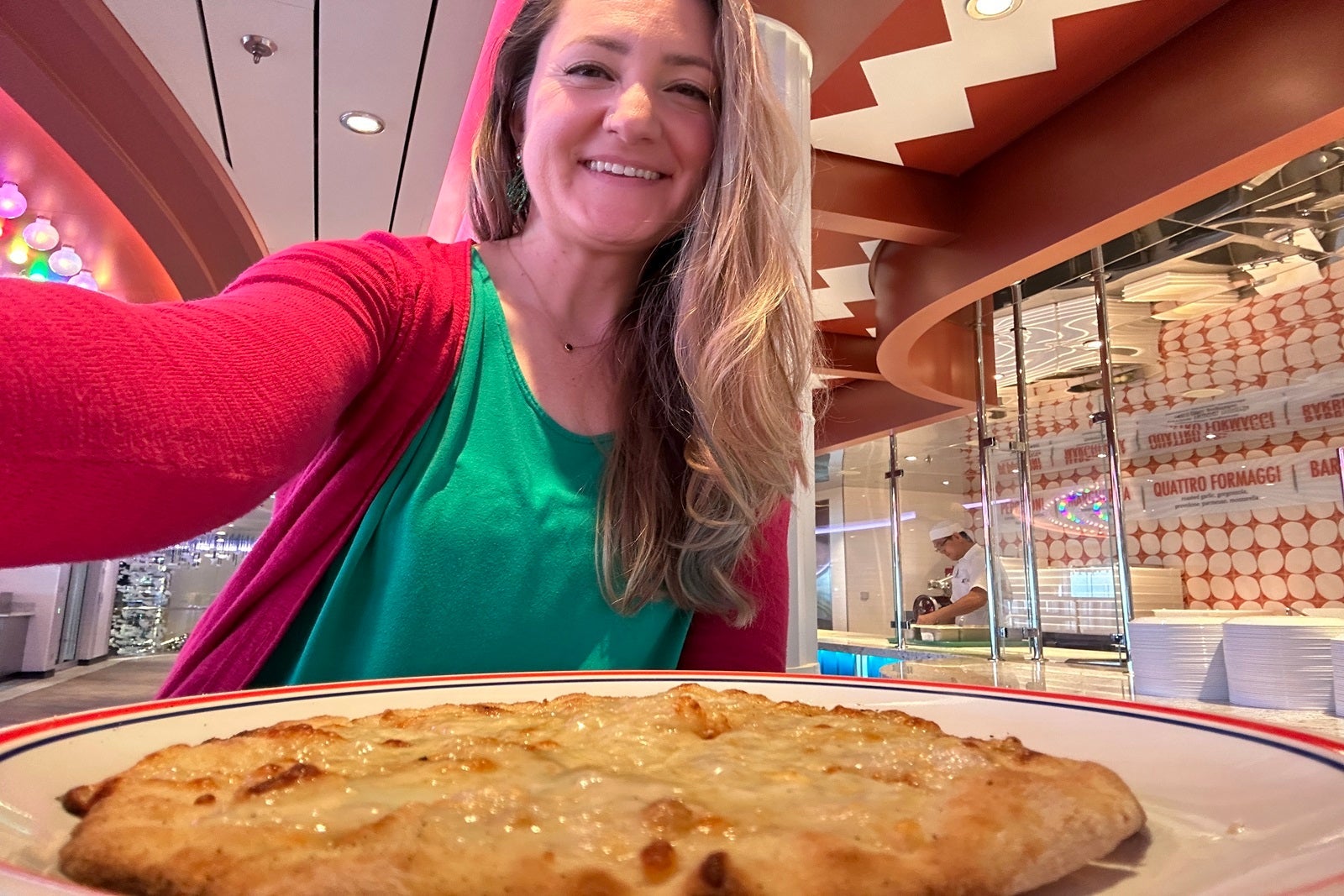 A woman with a whole pie of pizza