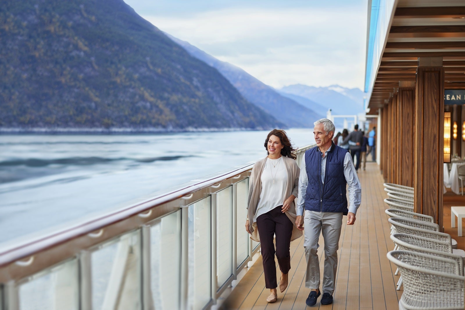 A couple walking on the deck of a cruise ship in Alaska