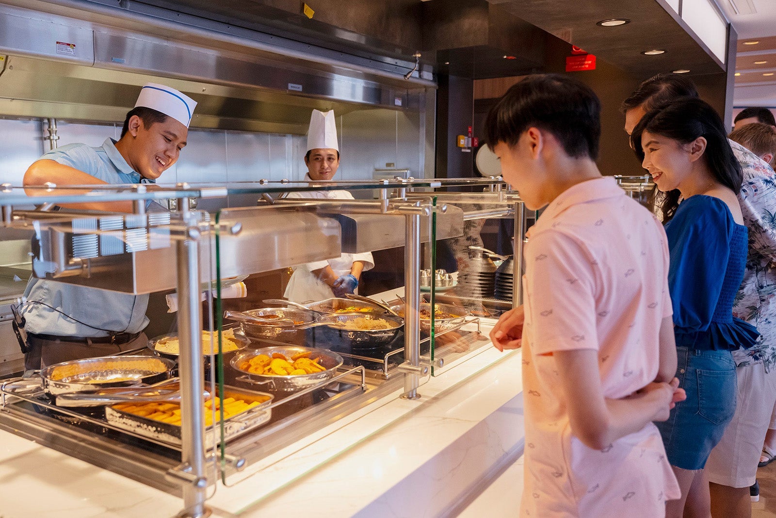 Man choosing food at Disney cruise ship buffet