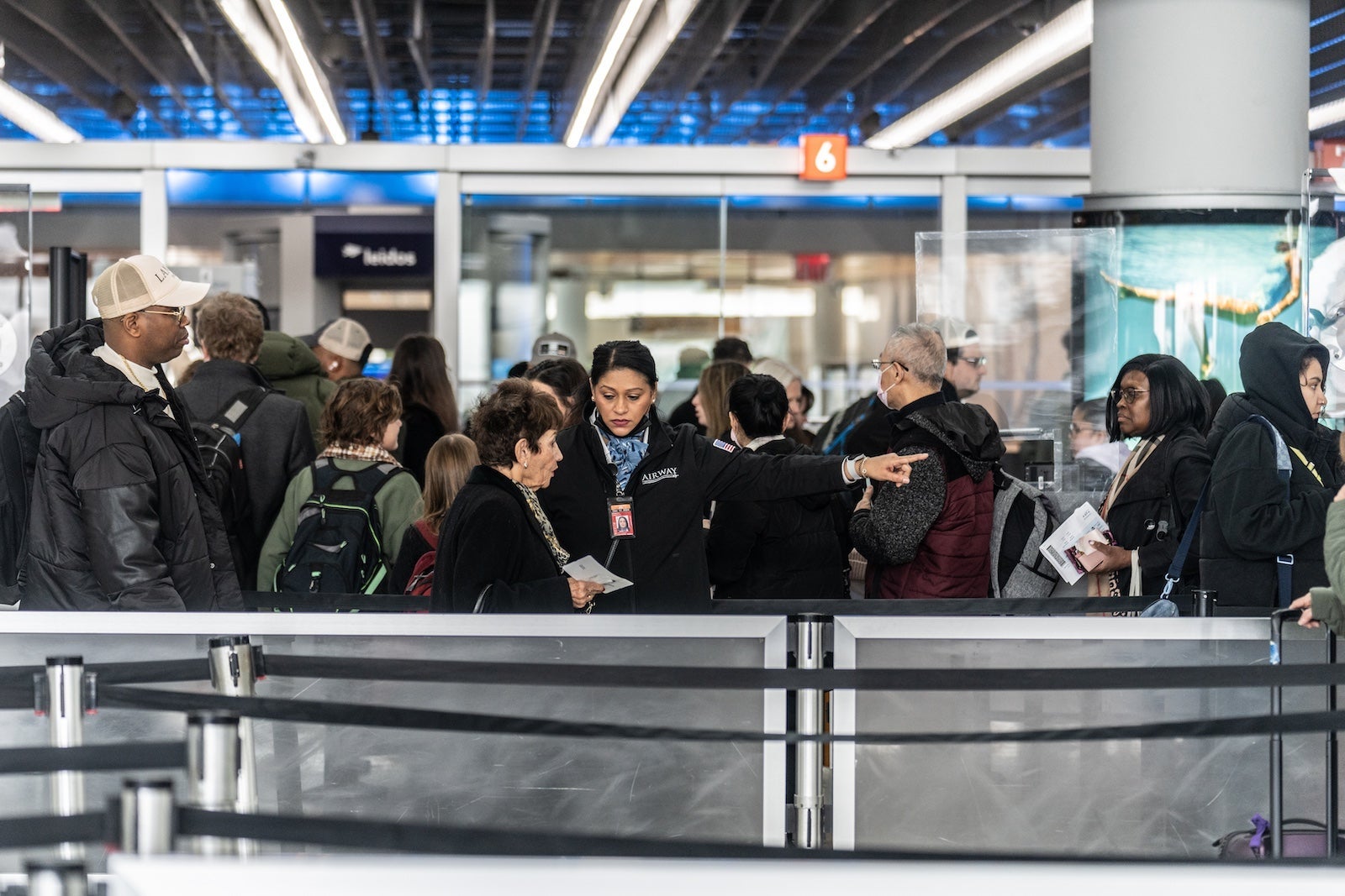 airport staff member helping passengers
