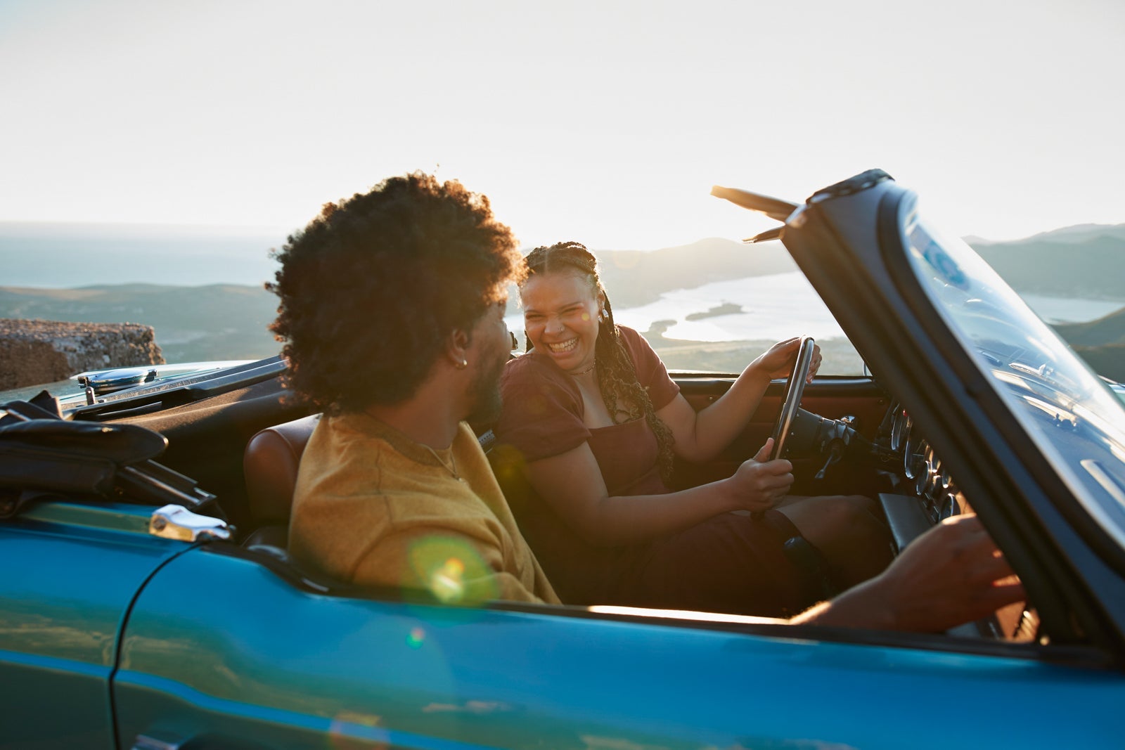 Woman driving with boyfriend sitting in car