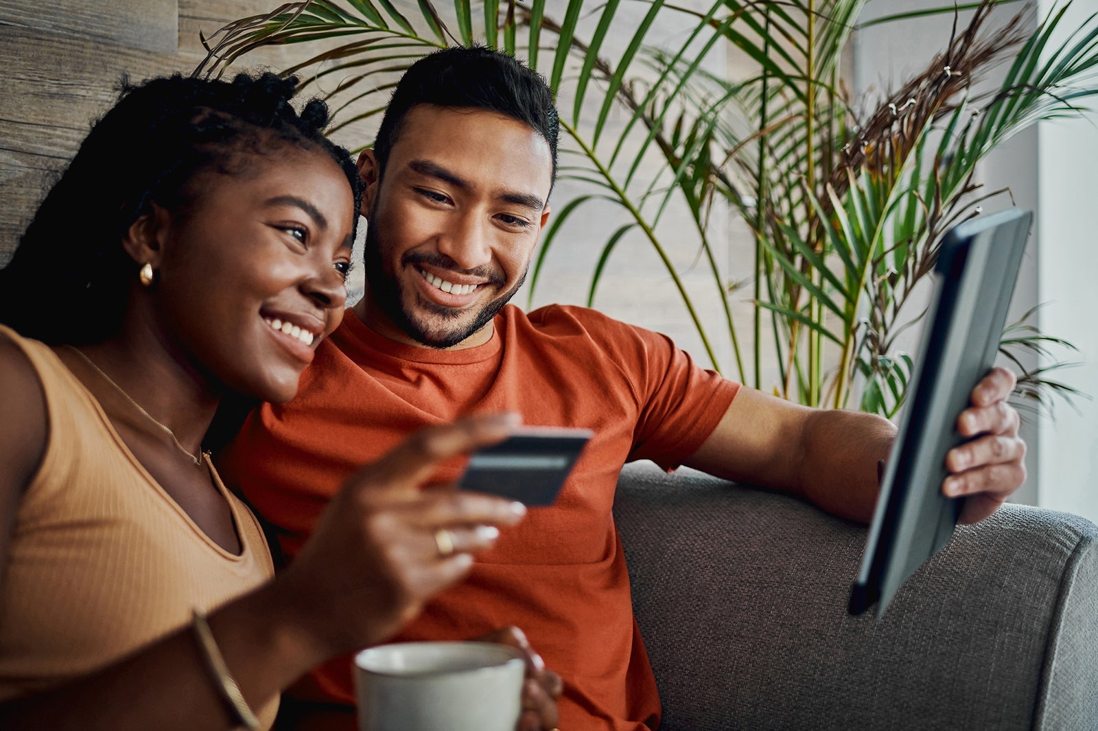 A couple looking at a tablet.